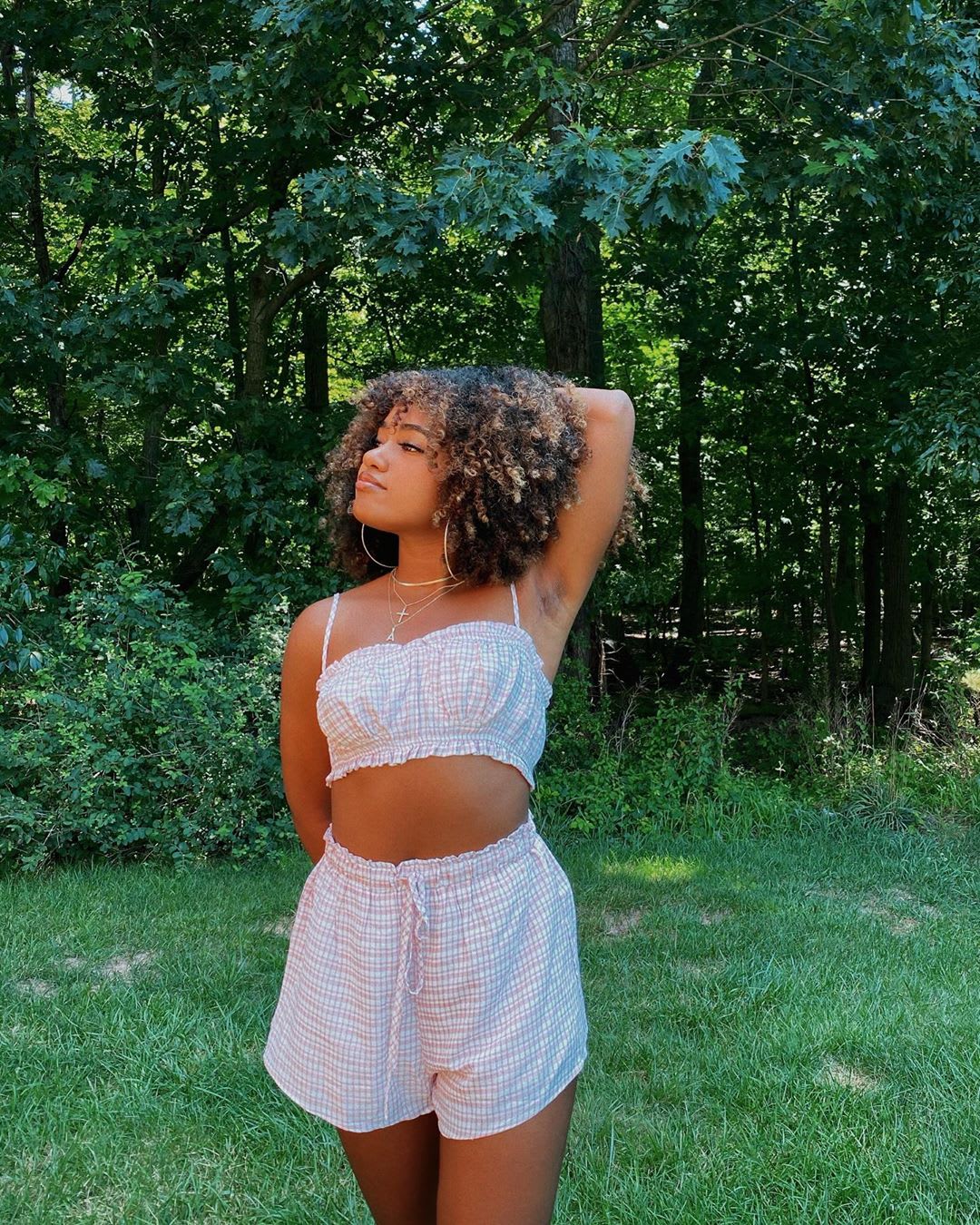 woman ina gingham matching set in the forest