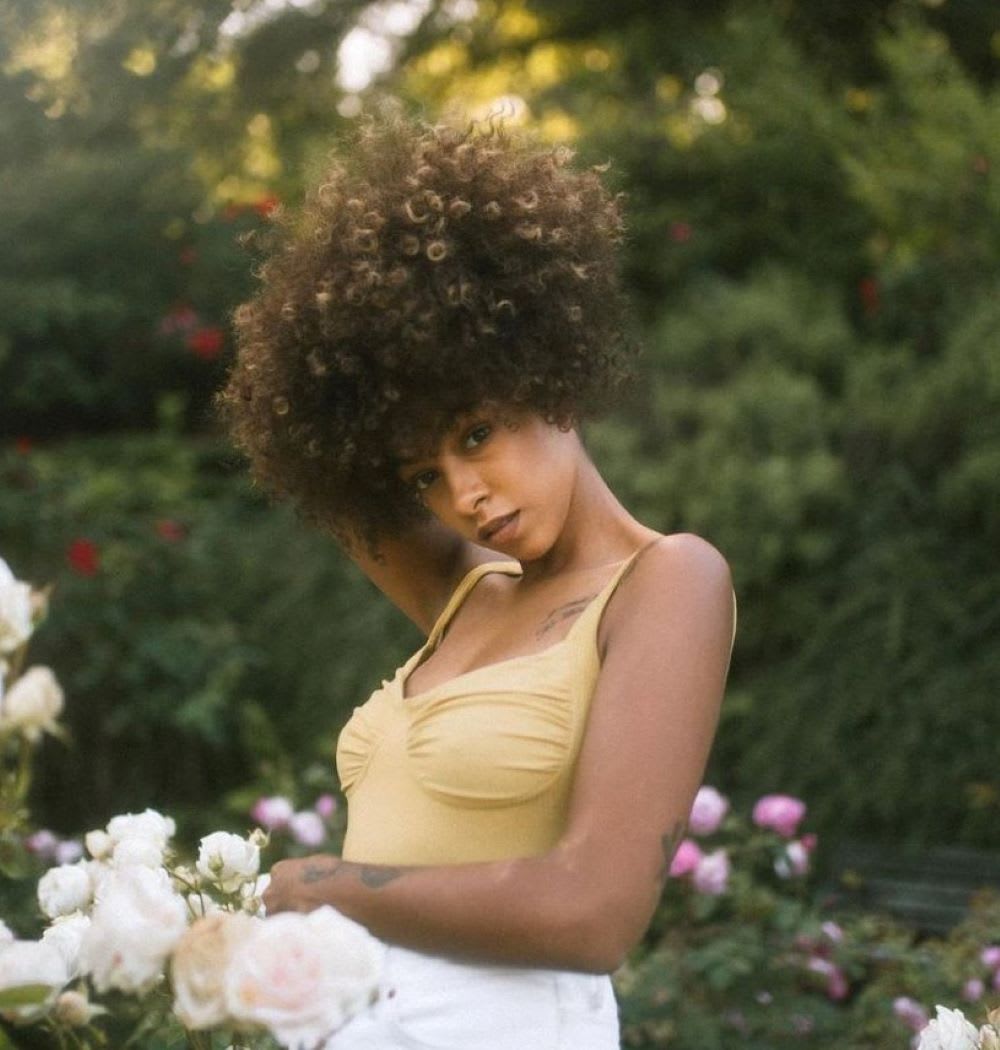 woman in a garden with natural curls