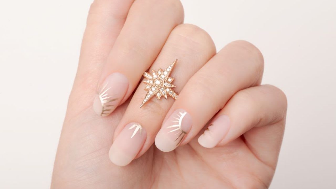 Elegant Nude Nail Design with Gold Sunburst