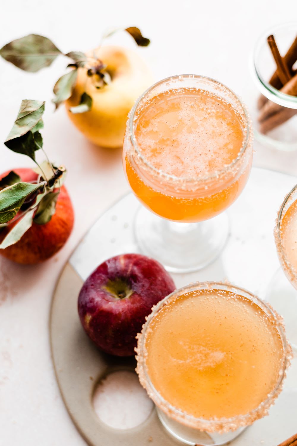 apple cider mimosas in glasses on a tray 