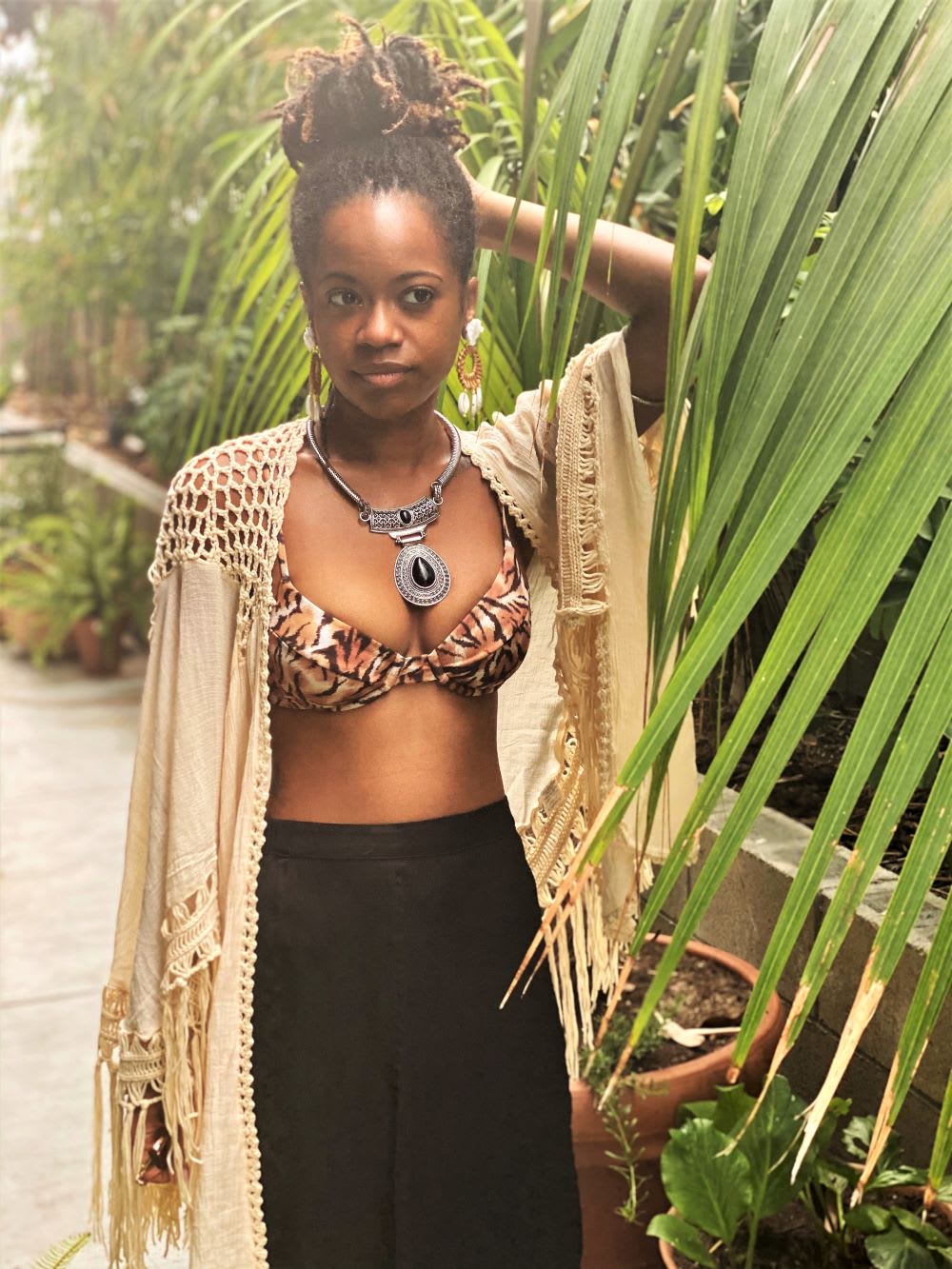 menstrual equity activist chelsea vonchaz of happy period wears a bikini top and fringe kimono
