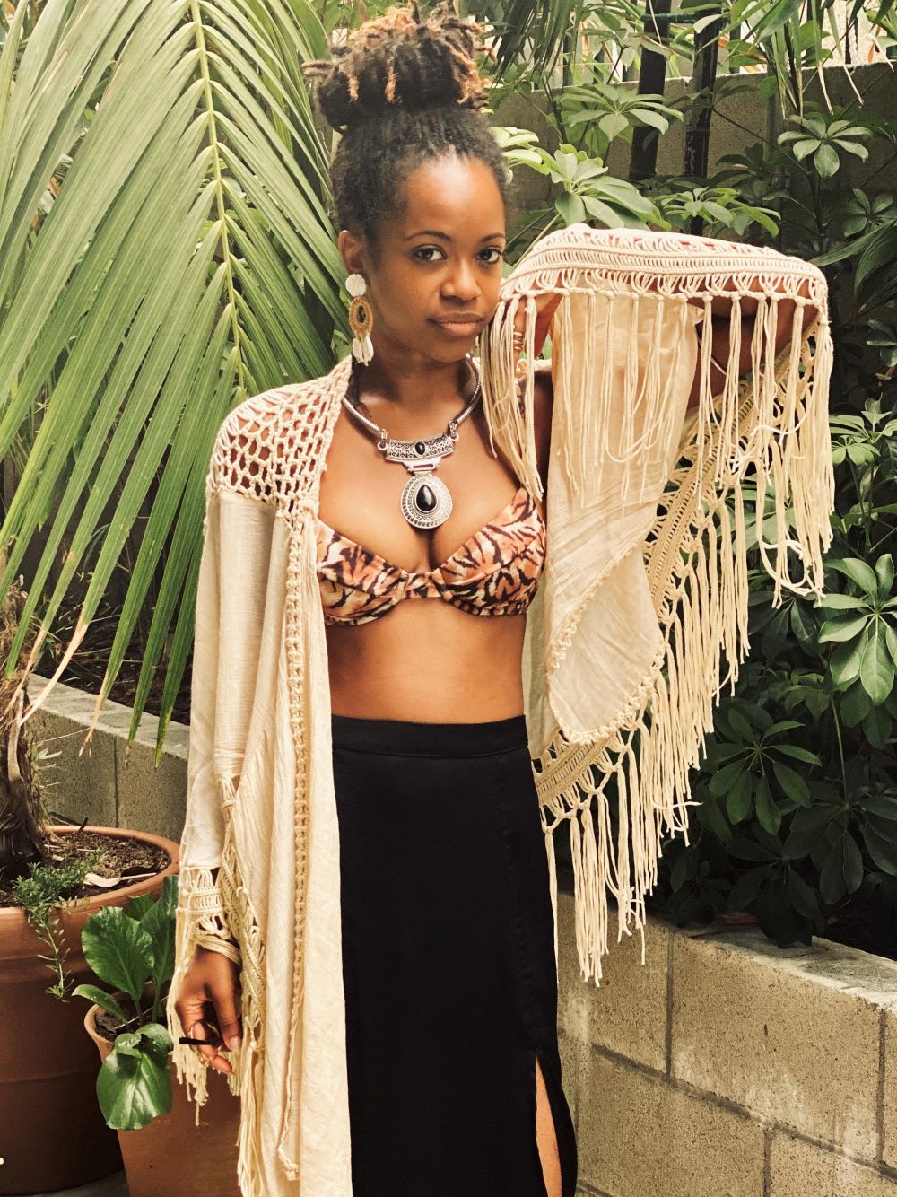 period poverty activist chelsea vonchaz of happy period wears a tiger print bikini top and fringe kimono