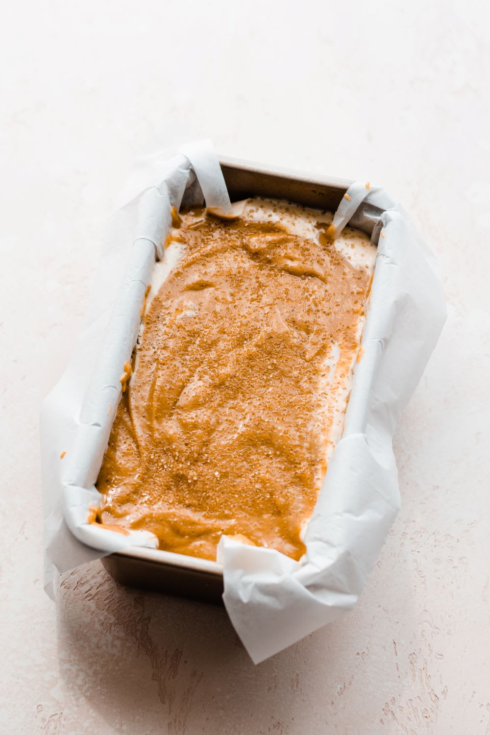 loaf pan with batter for pumpkin bread