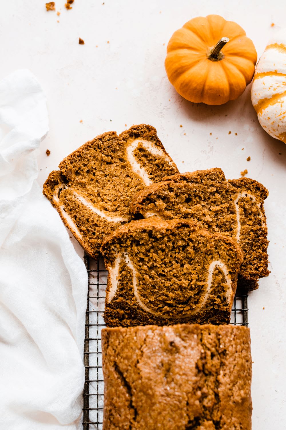 sliced loaf of pumpkin bread with cream cheese swirl