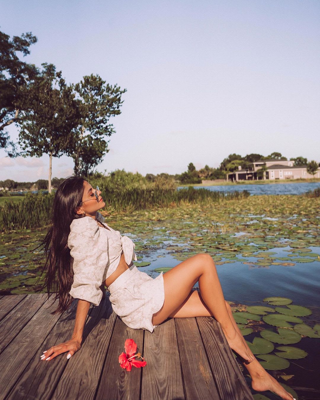 woman sitting on a dock taking in the outdoors and sunlight