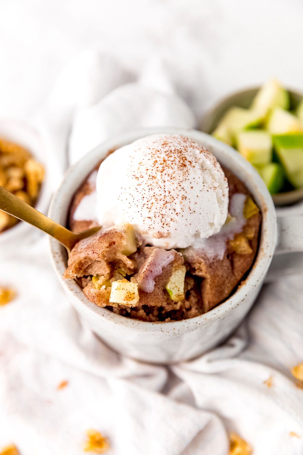 spoon in an apple spice mug cake