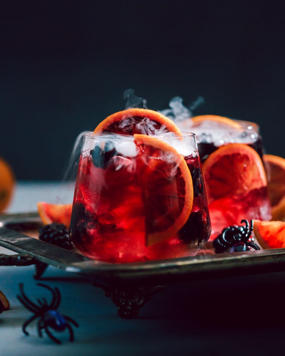 halloween cocktail with blood orange and blackberries