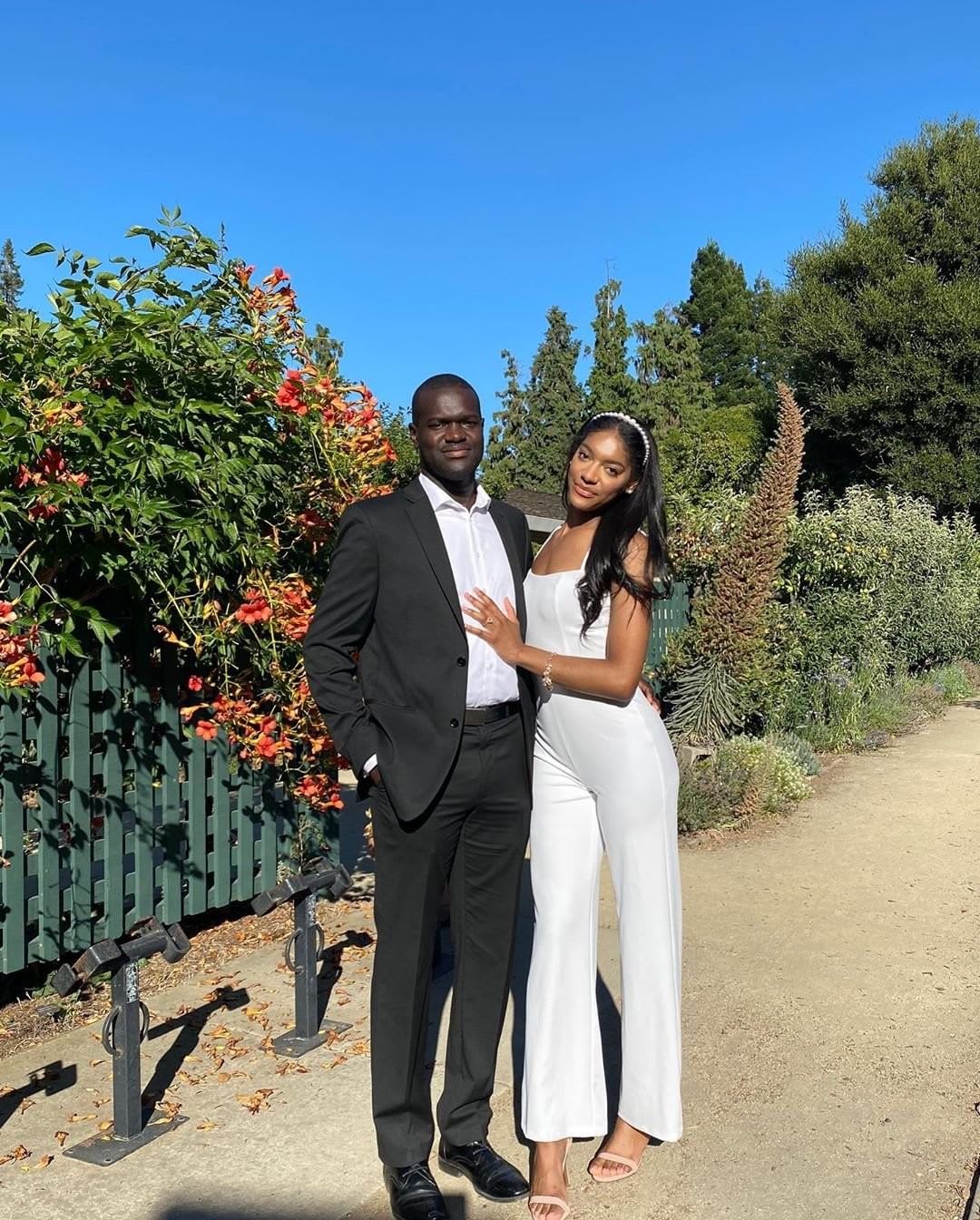 bride wearing a white jumpsuite from lulus with her groom