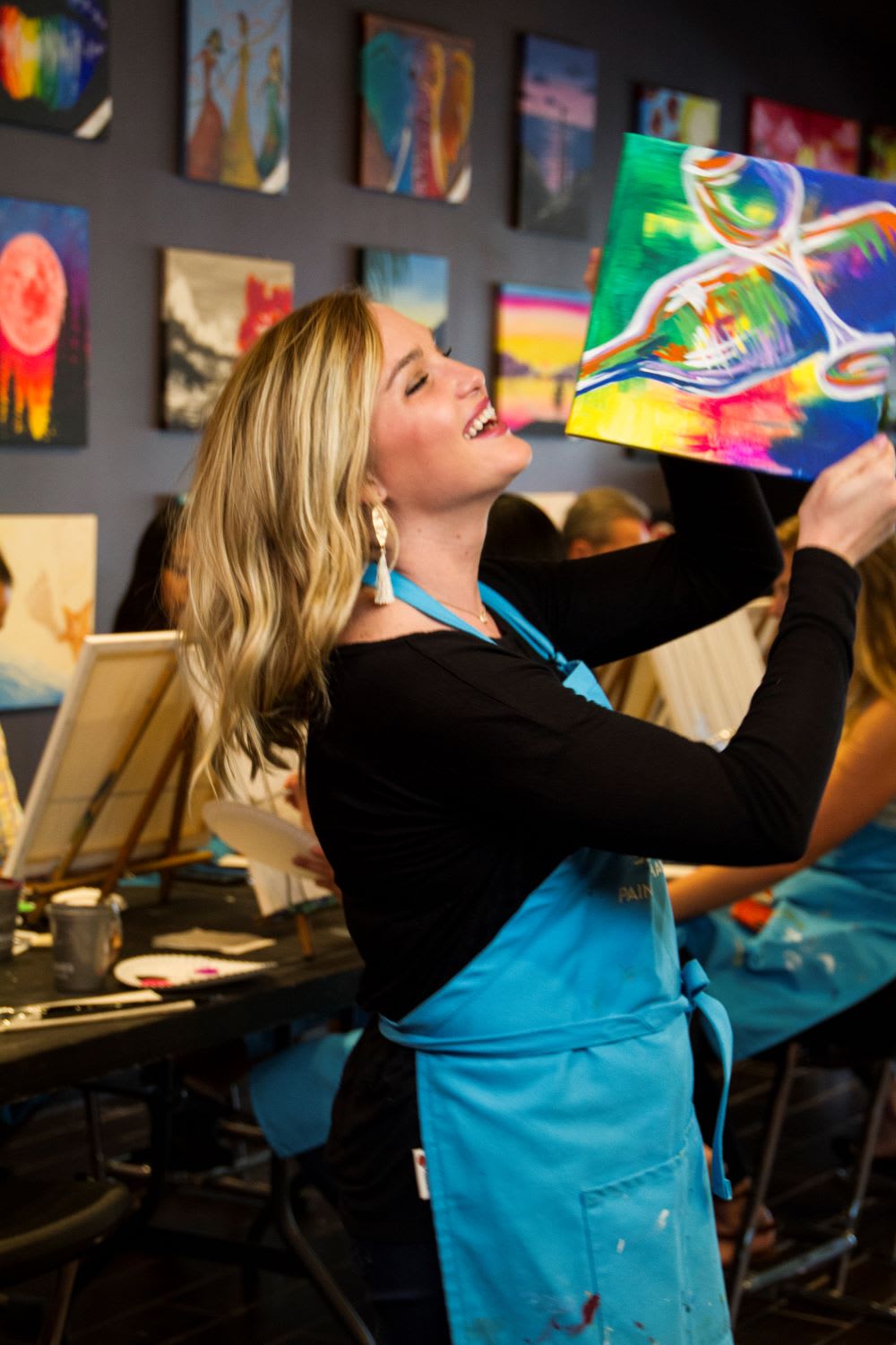woman holding up her painting