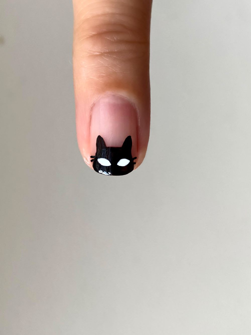 white eyes added to black cat nail art
