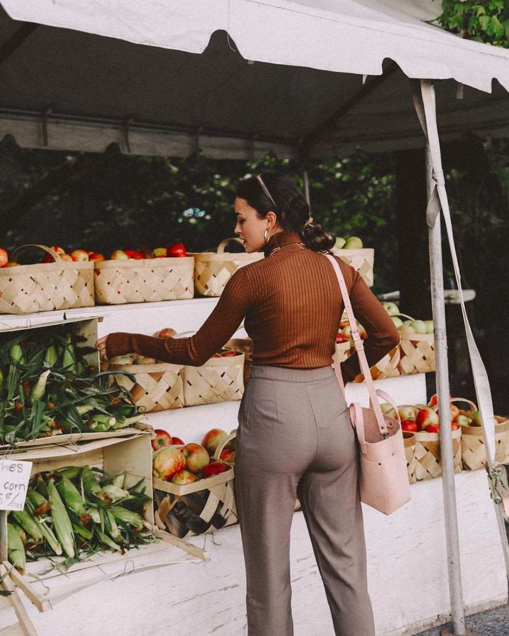 woman in brown turtleneck knit top shopping for vegetables to boost immune system