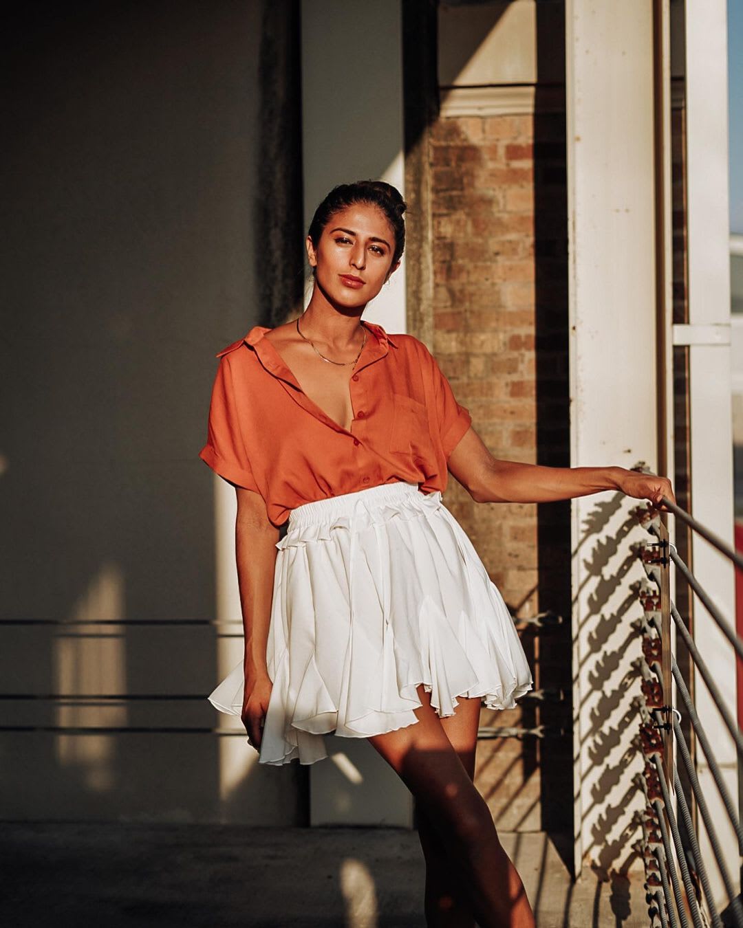 woman dressed in rust top and white skirt for outdoor thanksgiving