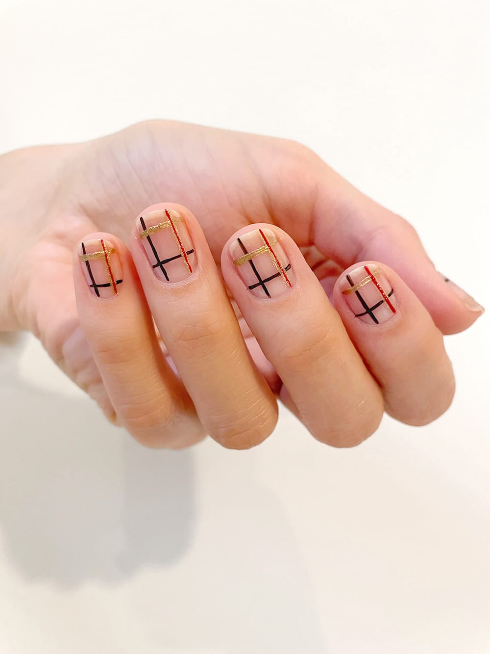 step 7 of plaid nail tutorial adding red lines