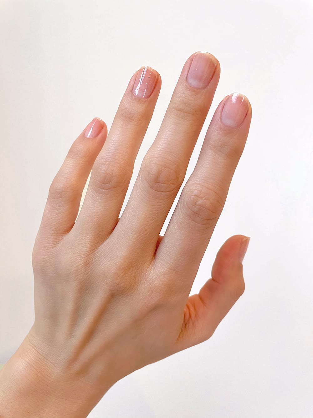 hand with clear nail polish 