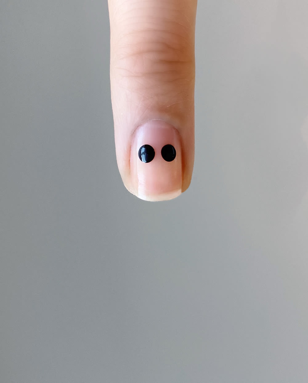 dots in black to start heart design on nail
