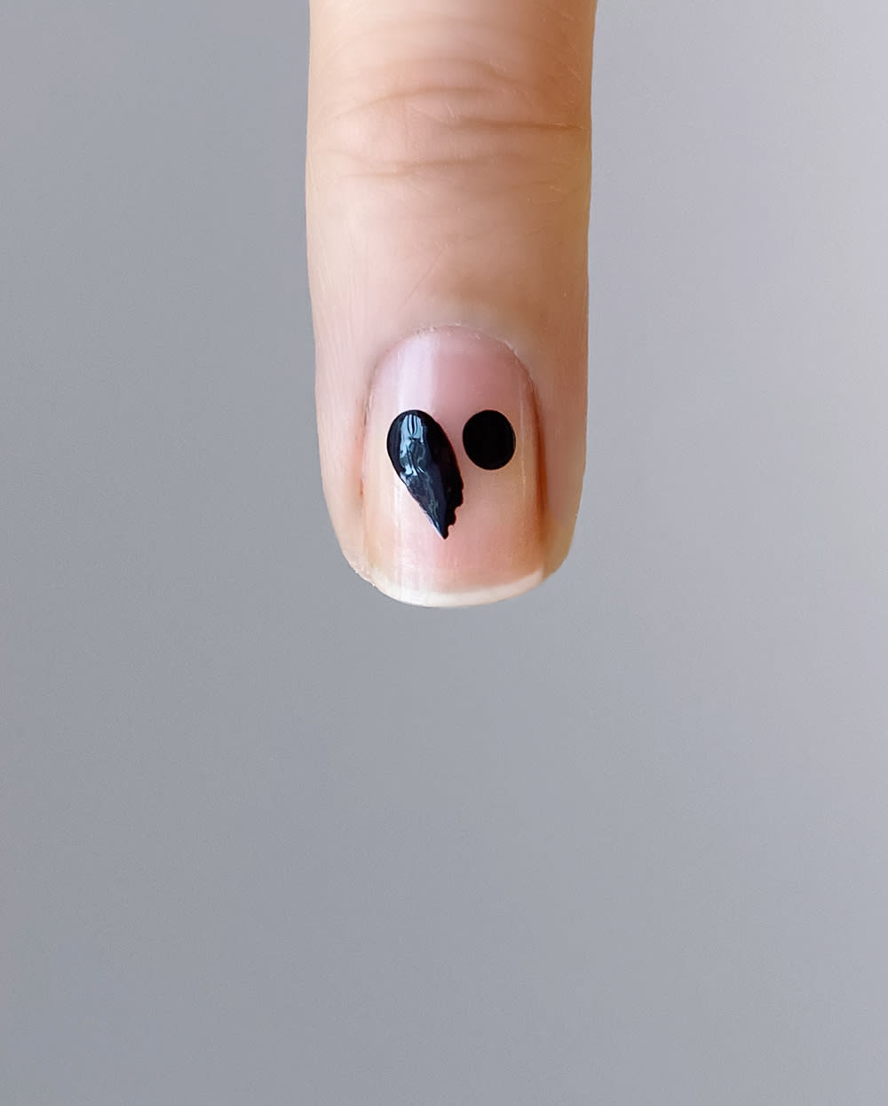 half of black heart drawn on nail