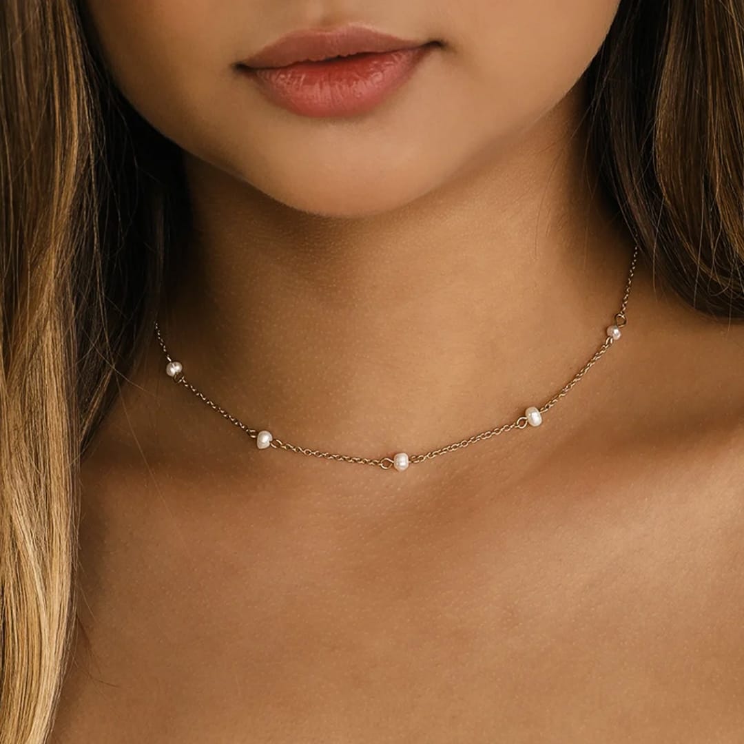 a neck with gold and pearl necklace