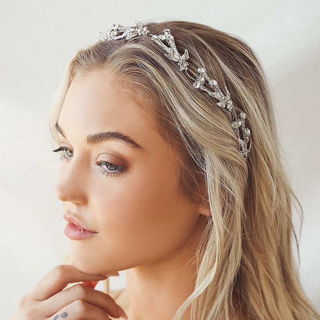 a woman wear a silver rhinestone headband in her hair