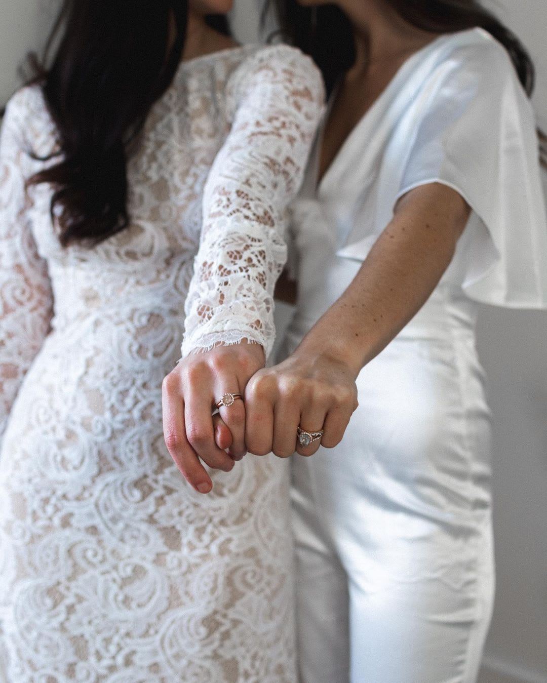 brides showing off rings while wearing wedding attire from lulus