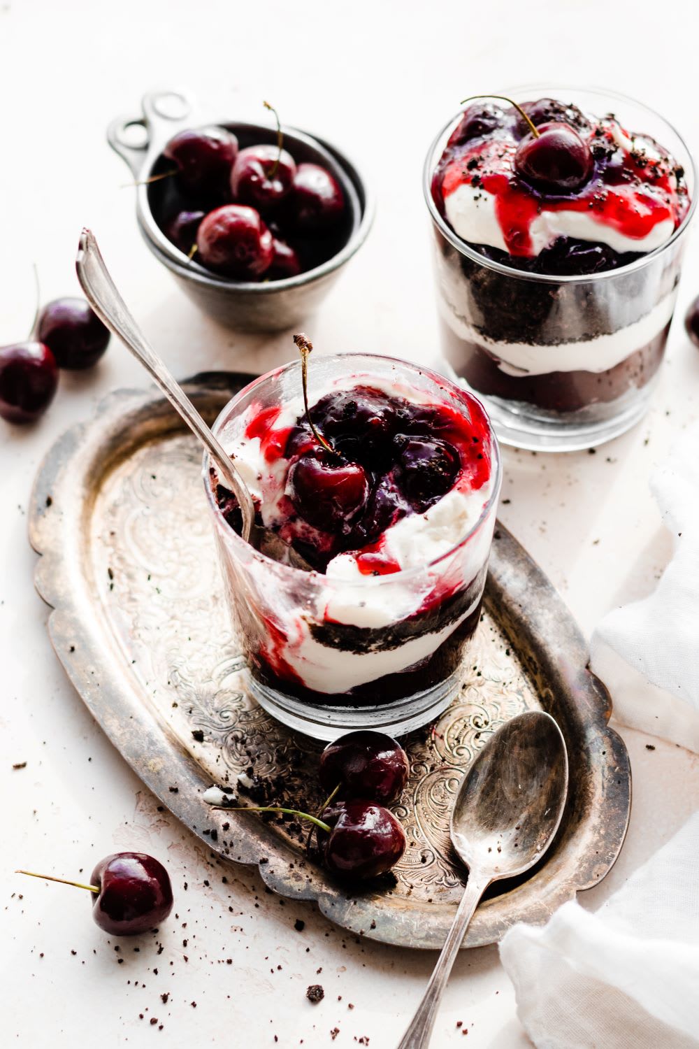 spoon in a glass with chocolate parfaits with cherries