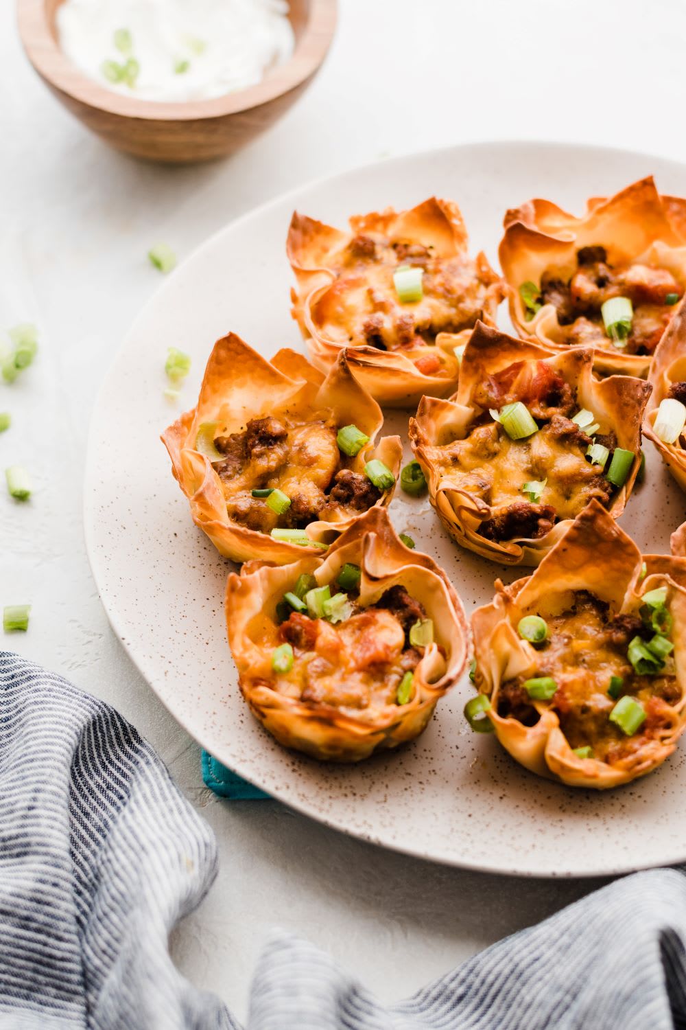 a plate full of taco cups for super bowl appetizer
