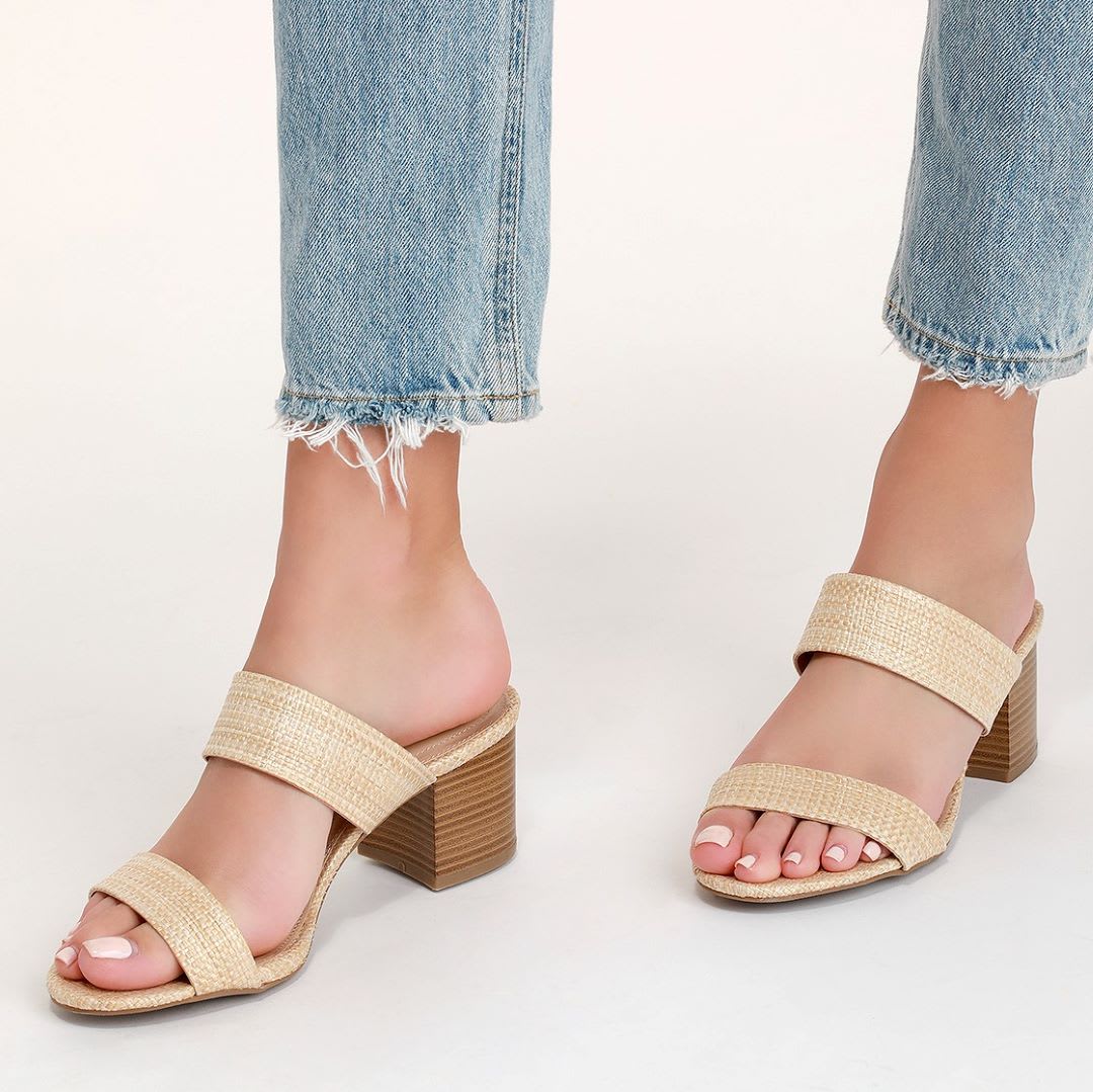 raffia mules on feet with hems of jeans showing