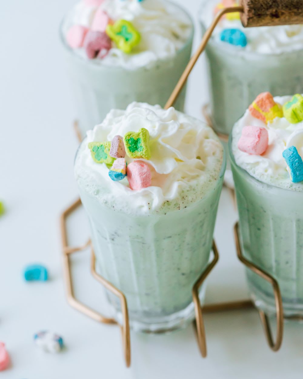 alcoholic shakes with mint ice cream and lucky charms marshmallows for st. paddy's day
