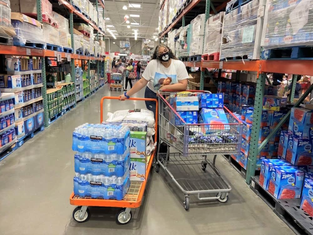 a woman shopping for bottled water and bulk supplies for community fridge