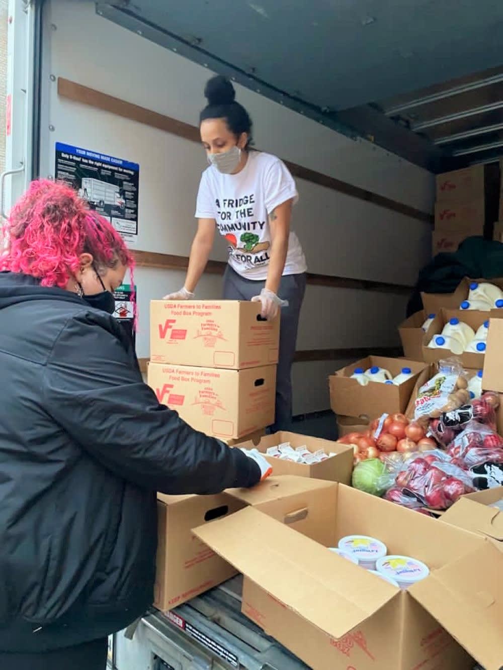 woman loading mutual aid supplies from a truck