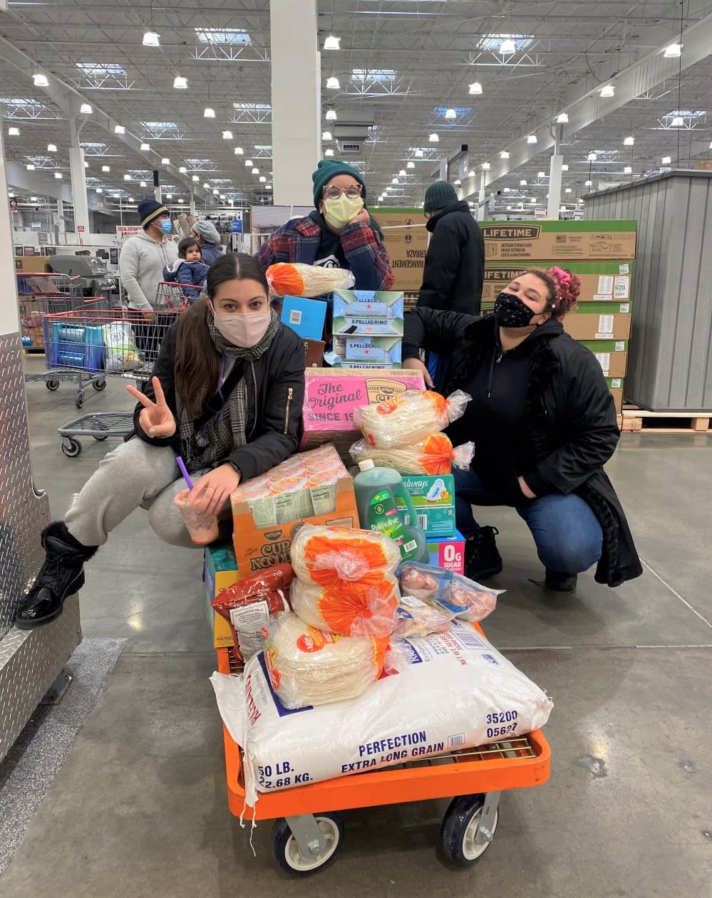 members of mutual aid group the fridge girls shopping in big box store for community fridge supplies