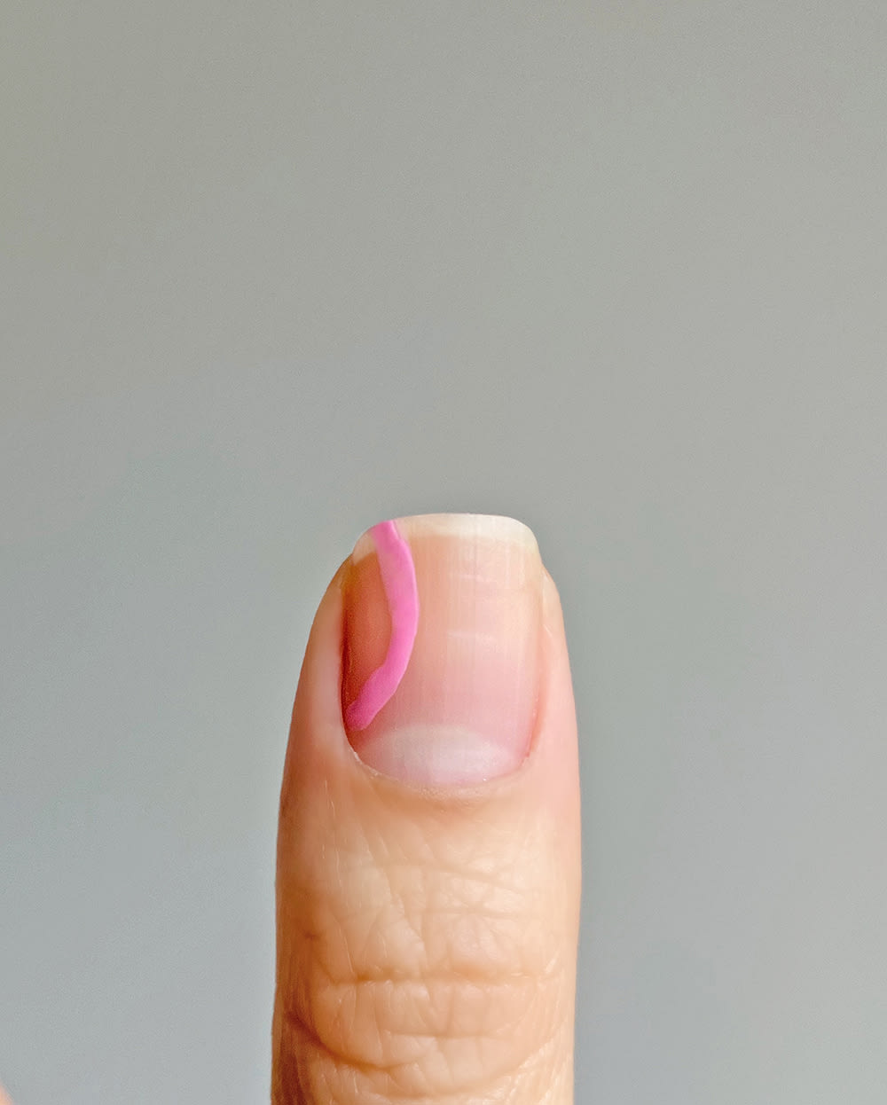 step 1 of pink shape on pastel nails