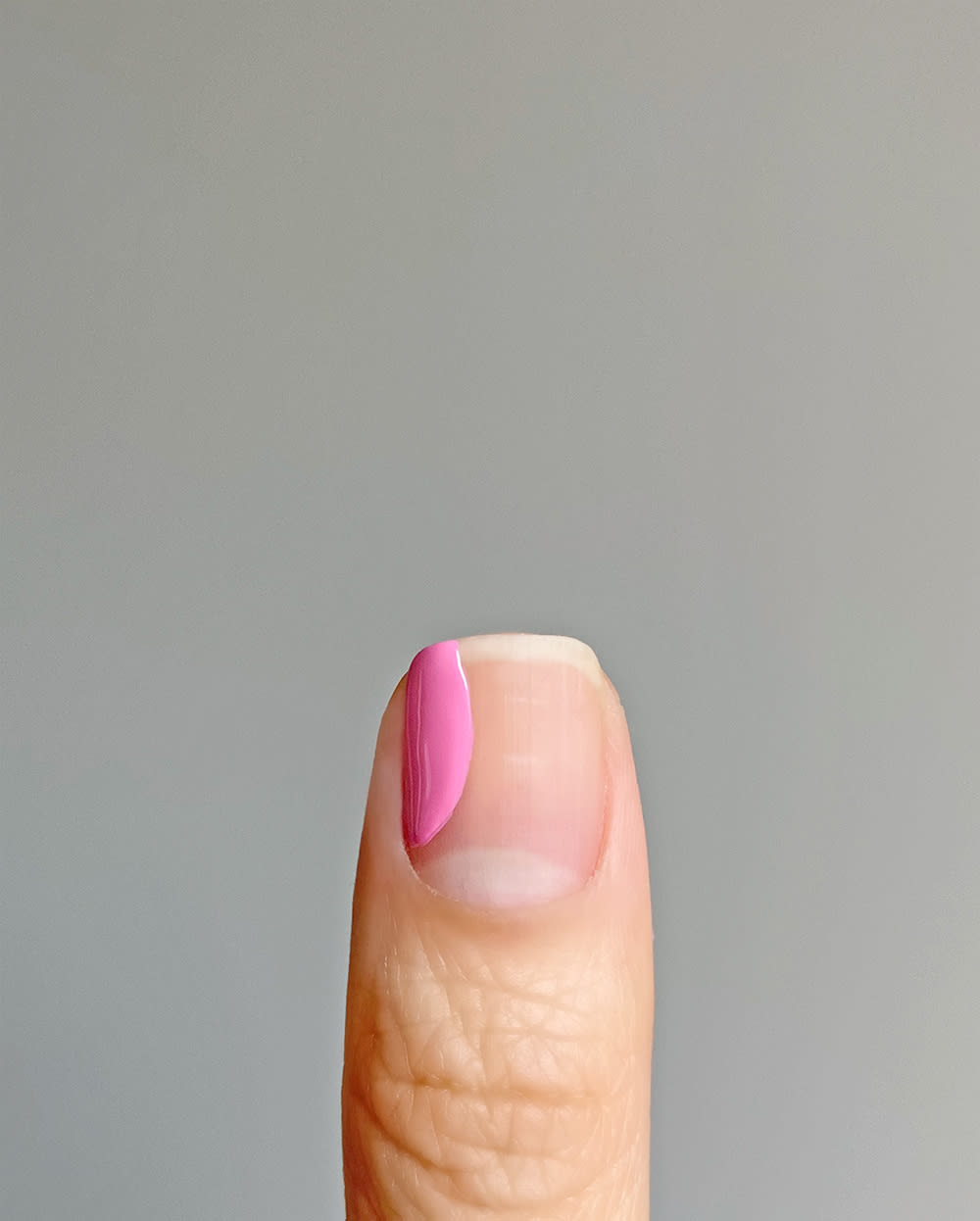 step 2 of pastel nail design where pink shape is filled in