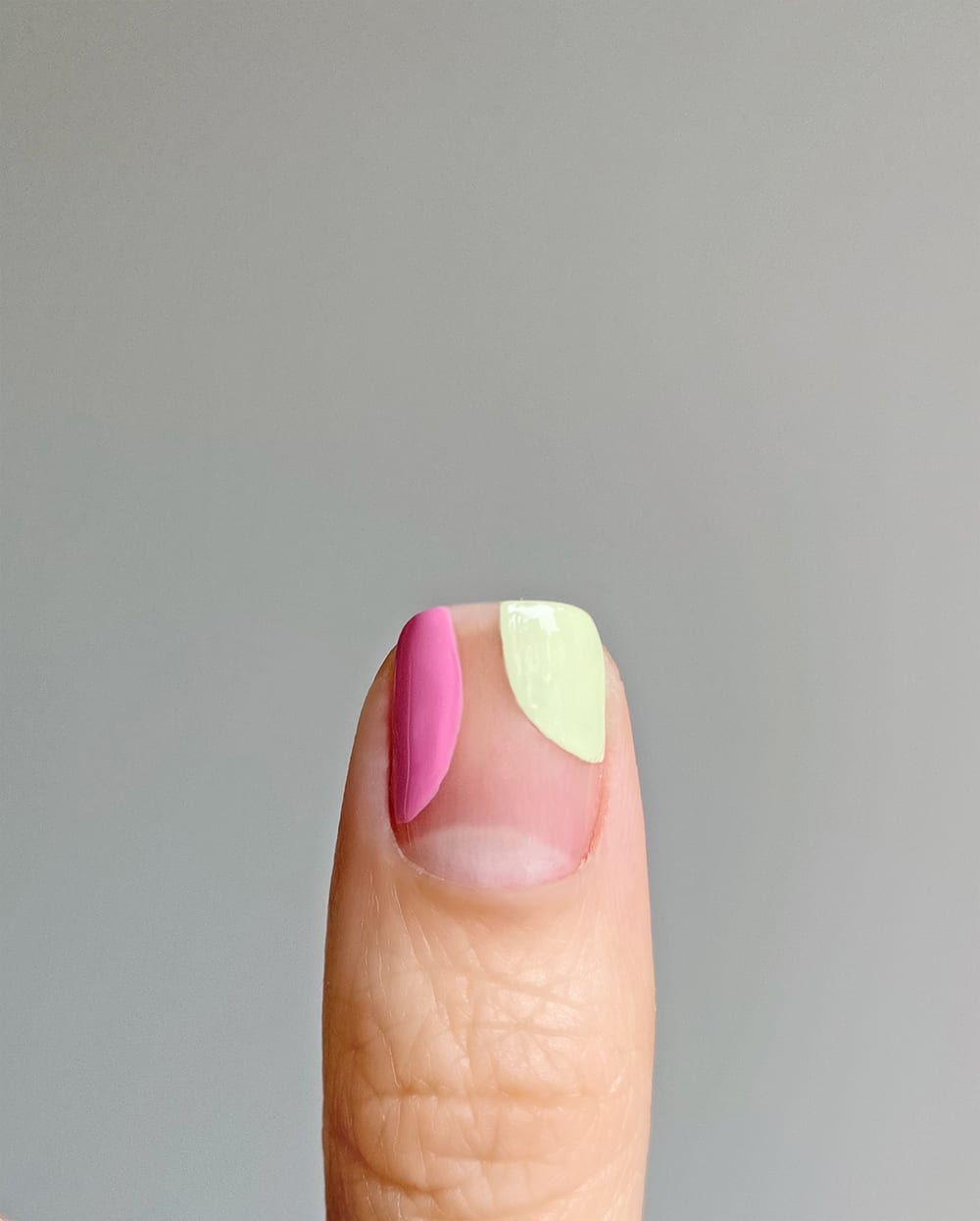 step 3 adding green shape to nail with pink shape for abstracct pastel design
