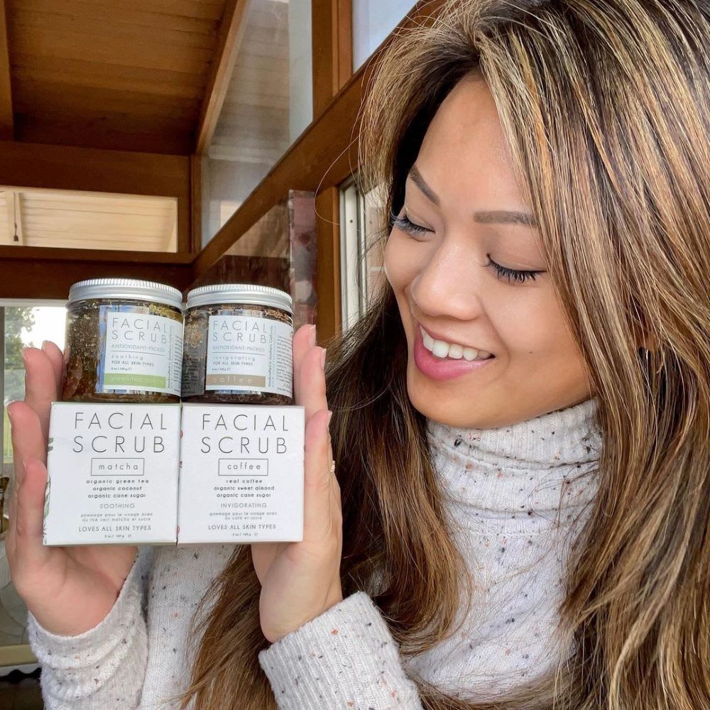 iris cherng, female founder of honey belle, poses with facial scrubs