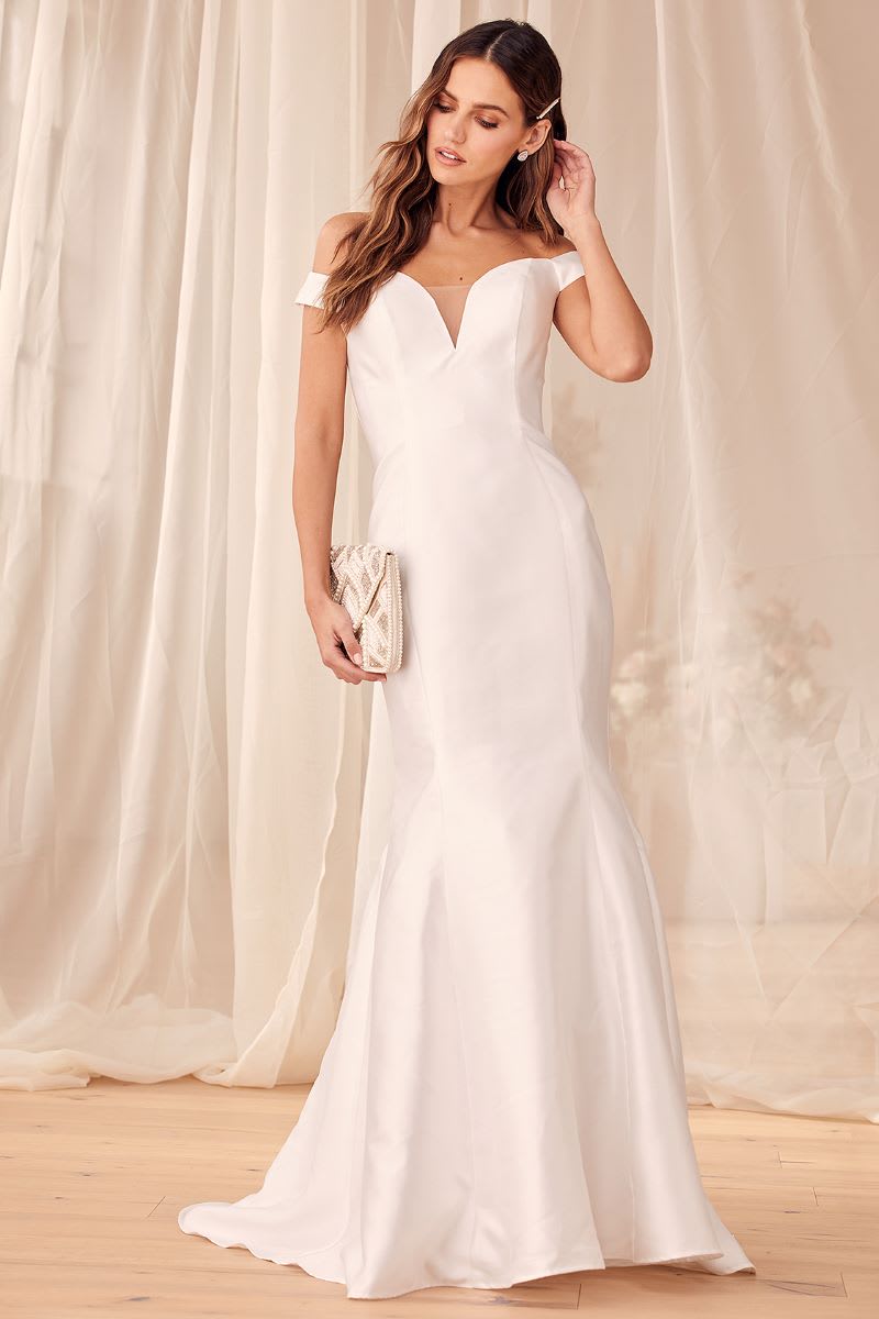 a woman wearing a taffeta off the shoulder mermaid wedding dress from lulus