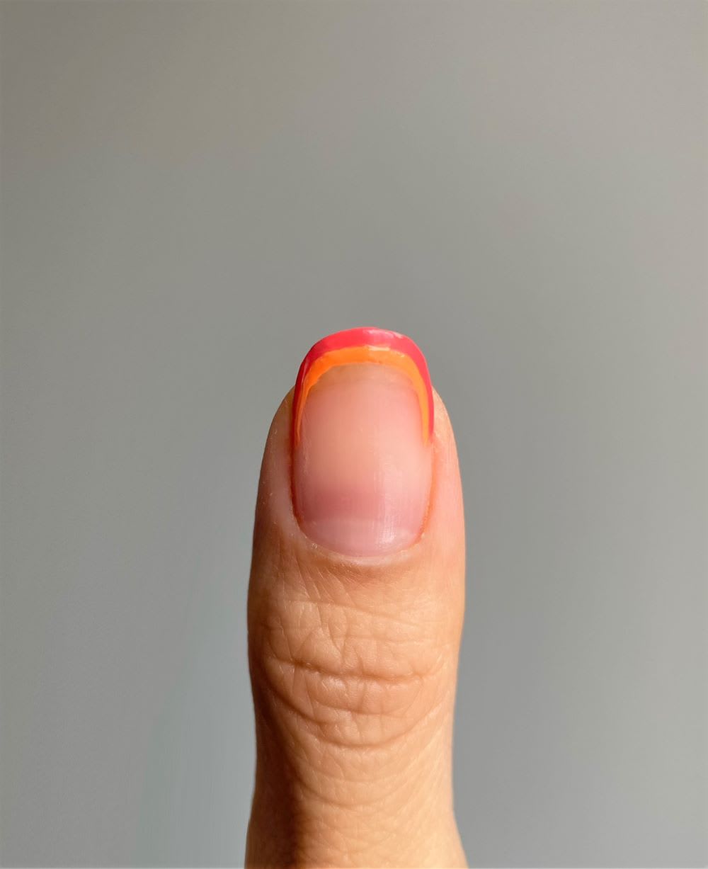 step 2 adding orange to rainbow on tip of nail