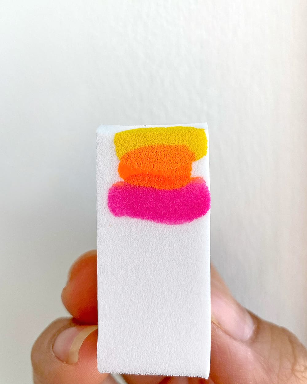 pink, orange, yellow desert nail polish colors on a makeup sponge