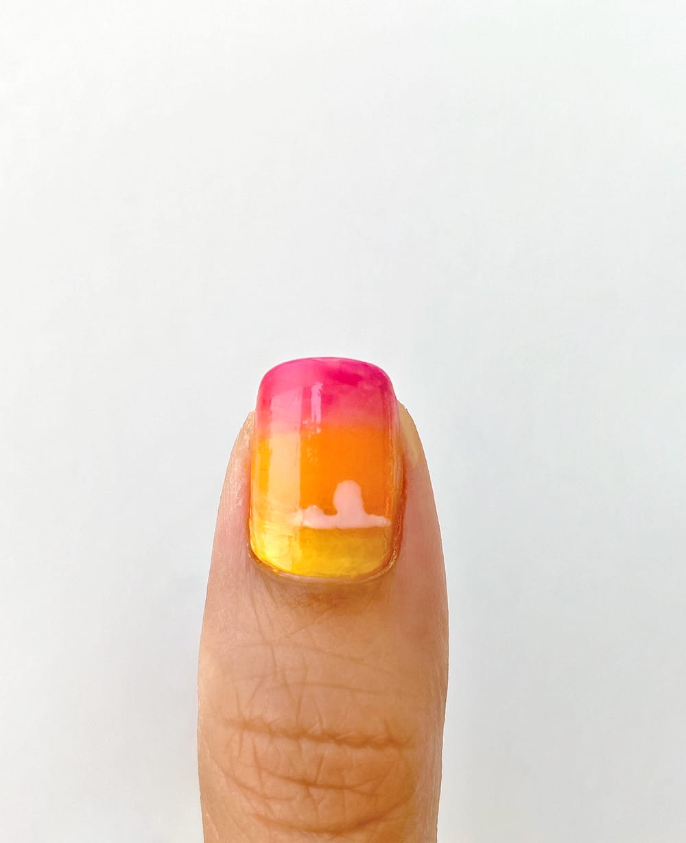 a desert nail with part of cloud painted