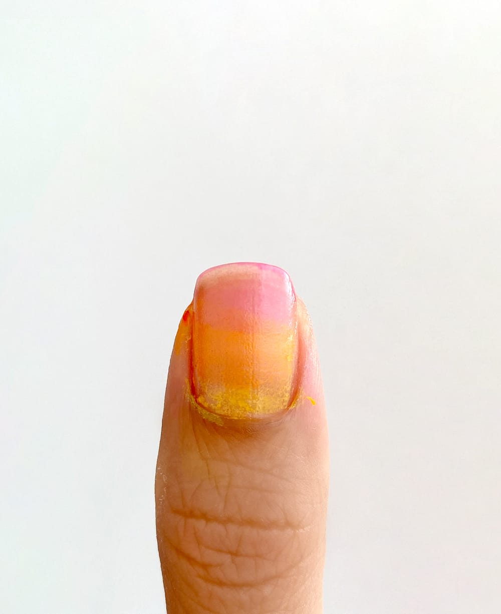 pink, orange, and yellow nail polish sponged onto nail