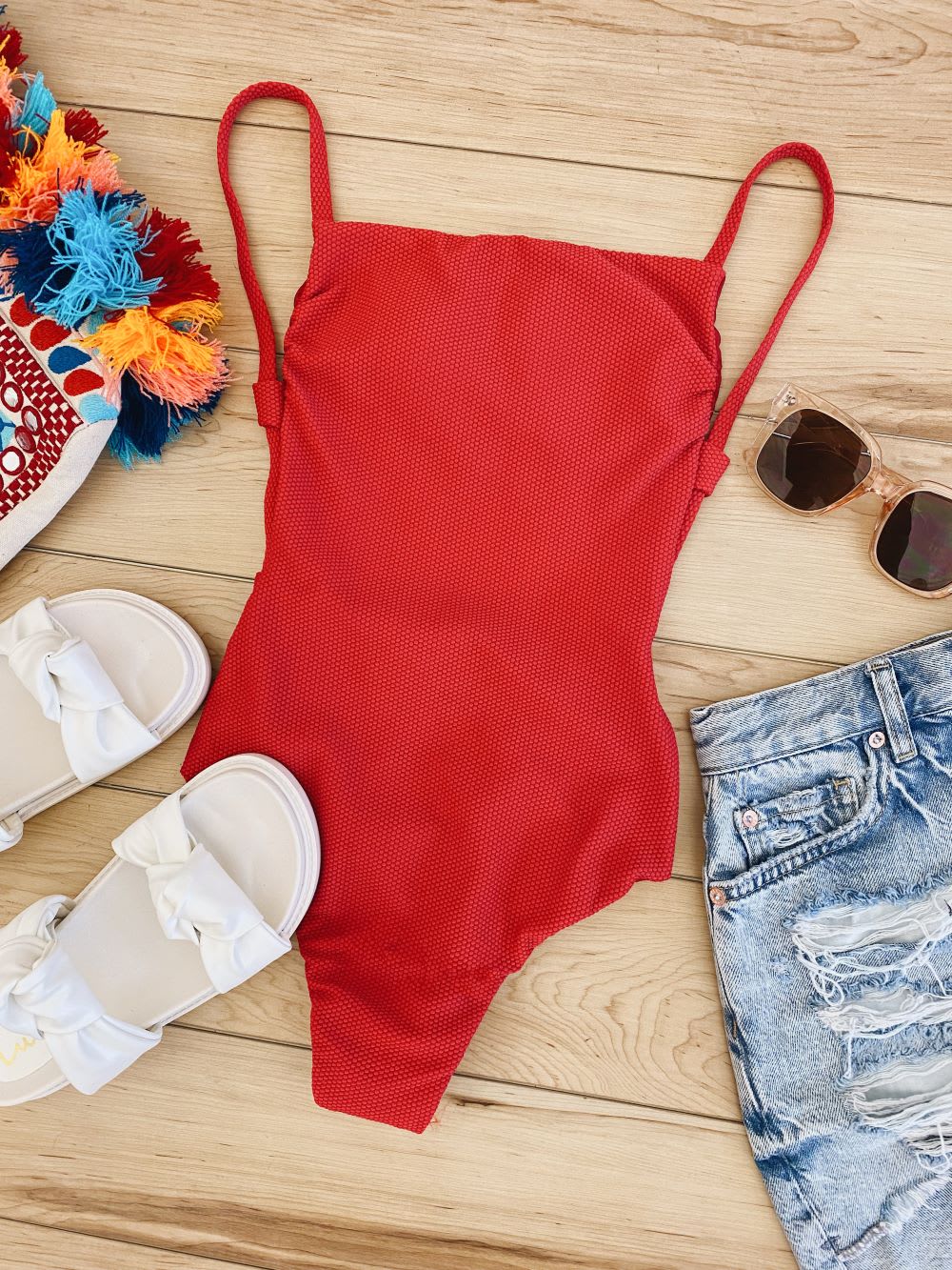 red one piece swimsuit and cutoffs