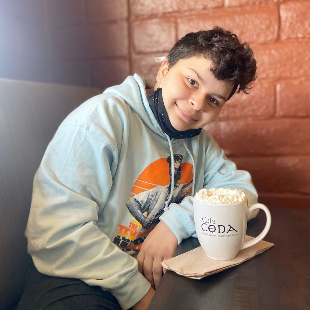 trans teen boy having coffee