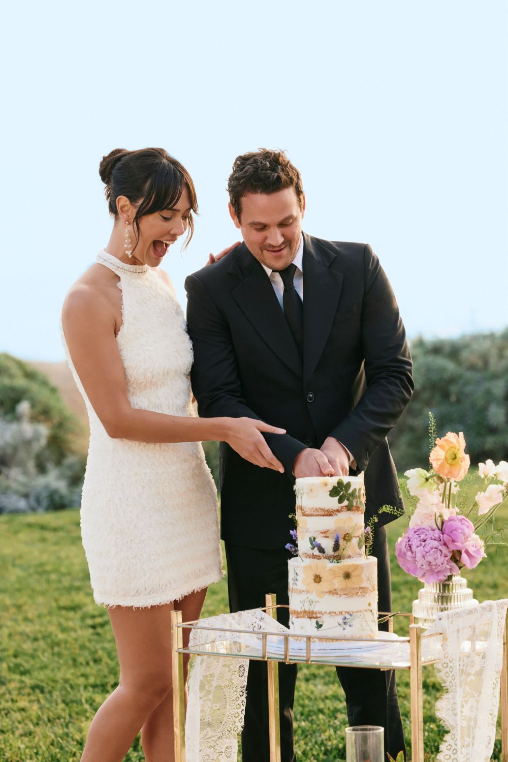 bride and groom cutting cake