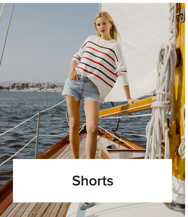 Shorts | Model in red, white, and blue sweater and denim cutoff shorts