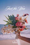 The gift card image, showing the text "Just for You" in white cursive script, over a photo of a hand holding a colorful bouquet of roses, orchids, gerbera daisies, and tropical foliage at the beach