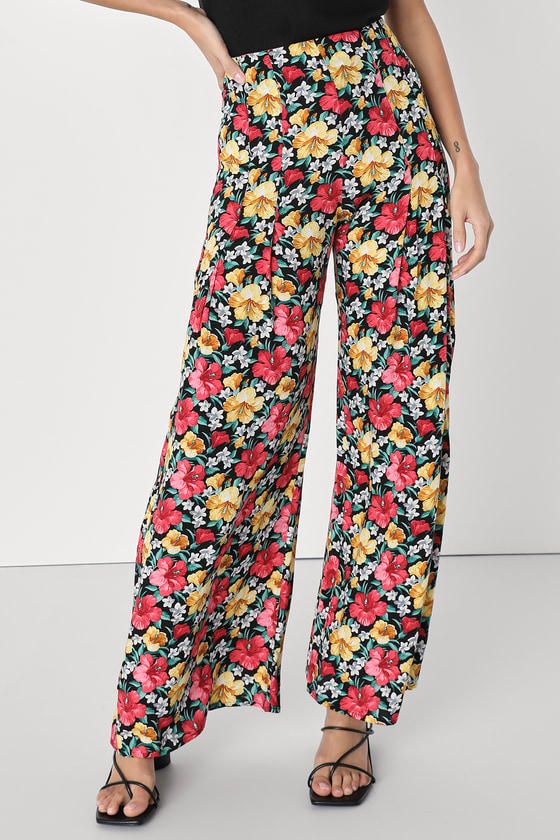 Model black, yellow, and red floral wide leg pants from Lulus
