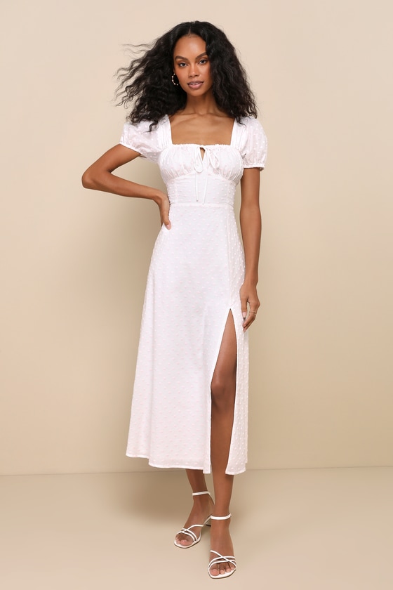 Model wearing a white and pink polka dot midi dress from Lulus