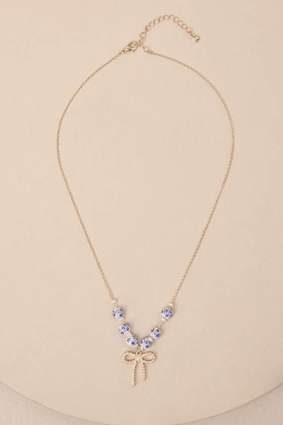 LULUS DARLING ALWAYS GOLD BEADED BOW CHARM NECKLACE