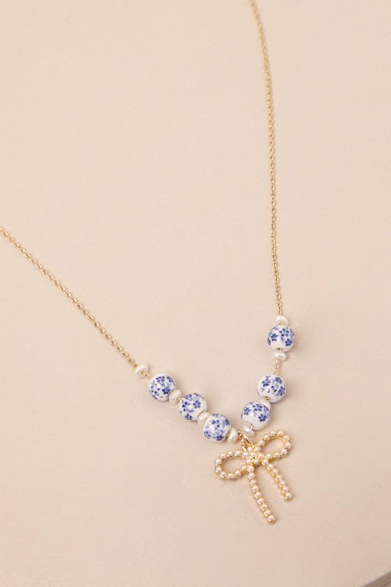 LULUS DARLING ALWAYS GOLD BEADED BOW CHARM NECKLACE