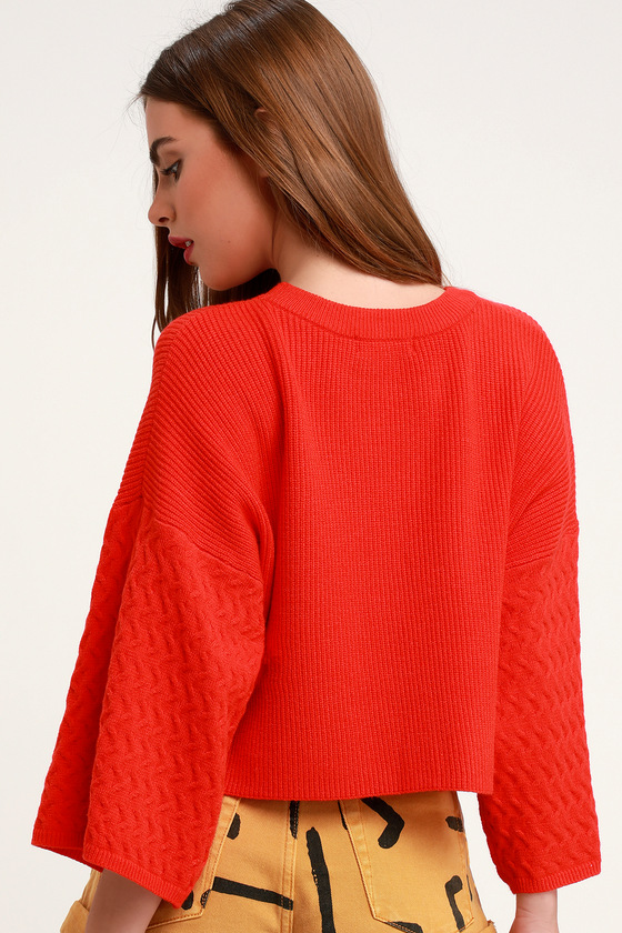 red sweater with bell sleeves