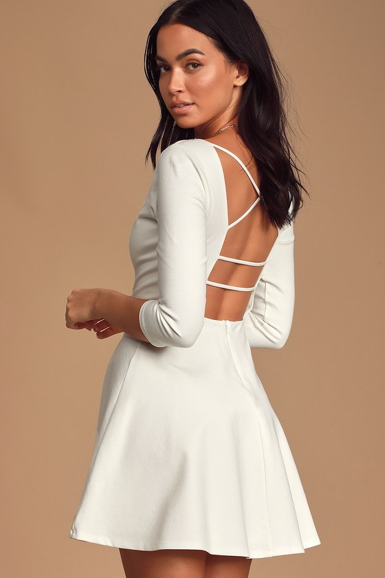 Don't Stop the Beat White Backless Skater Dress - Lulus Exclusive! If you aren't ready to show 'em how you shake it, try slipping into the Lulus Don't Stop the Beat White Backless Skater Dress! This confidence-boosting little number has a medium-weight stretch knit construction that shapes a princess-seamed bodice, with a plunging neckline, and strappy, open back, all framed by three-quarter length sleeves. Fitted waist flares into a flirty skater skirt. Hidden back zipper.